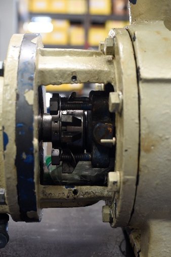 Close view of the bearing frame and coupling end before teardown