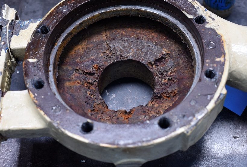 Interior of the original casing showing heavy corrosion and pitting