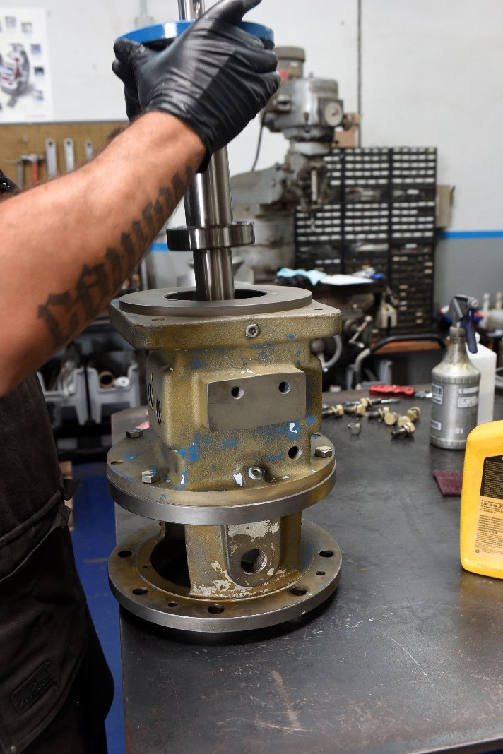Technician lowering the new shaft into the bearing frame