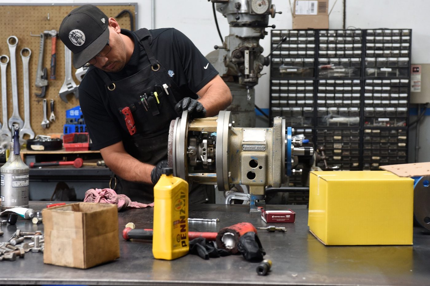 Technician completing final assembly of the rebuilt pump